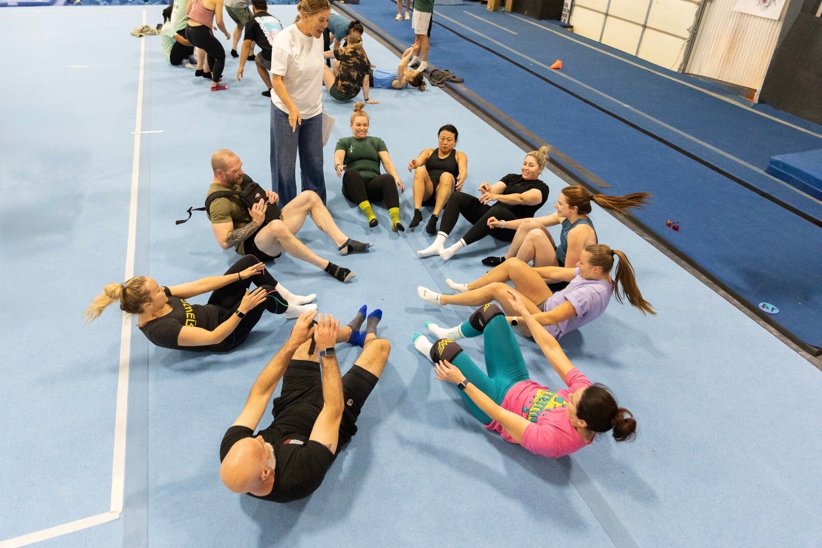 Power Monkey Fitness coaches teaching gymnastics and Olympic weightlifting to a group of adult athletes